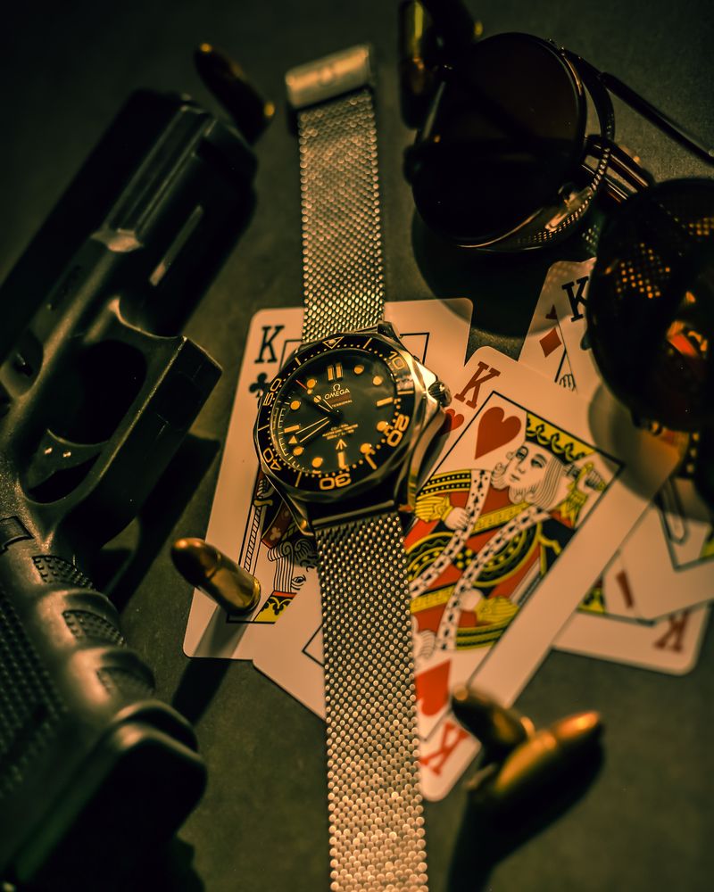 James Bond spy gear flatlay — watch, sunglasses, and accessories