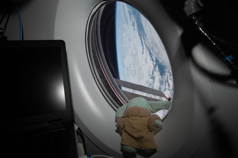 Grogu (Baby Yoda) figurine watching Earth from the SpaceX Crew Dragon on the ISS